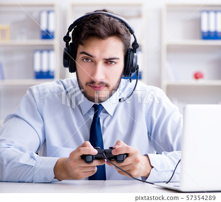 Businessman gamer in office playing games Businessman gamer in office playing games 57354289