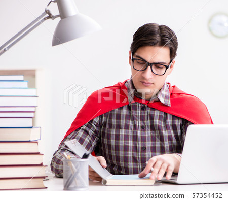 Super hero student with a laptop studying preparing for exams Super hero student with a laptop studying preparing for exams 57354452