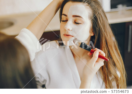 The girl wears a mask on her face 57354673