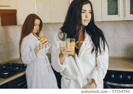 two girls with juice two girls with juice 57354740