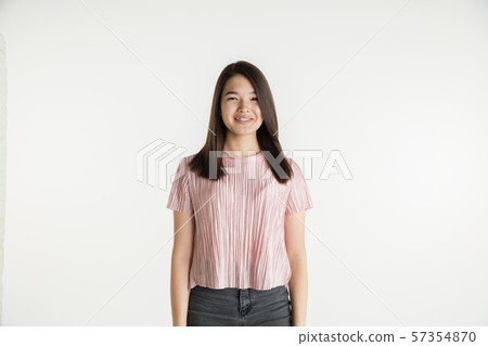 Beautiful girl's half-length portrait on white studio background Beautiful girl's half-length portrait on white studio background 57354870