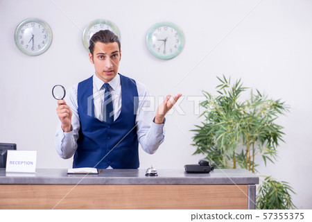 Young man receptionist at the hotel counter 57355375