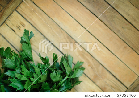 Bunch of fresh parsley celery on a wooden table. Healthy eating, raw food concept background. Fresh Bunch of fresh parsley celery on a wooden table. Healthy eating, raw food concept background. Fresh 57355460