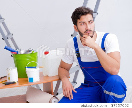 Repairman doing renovation repair in the house with paper wallpa 57357002