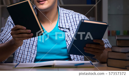 Student preparing for exams late night at home 57357372