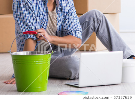 Young painter contractor choosing colors for home renovation Young painter contractor choosing colors for home renovation 57357639