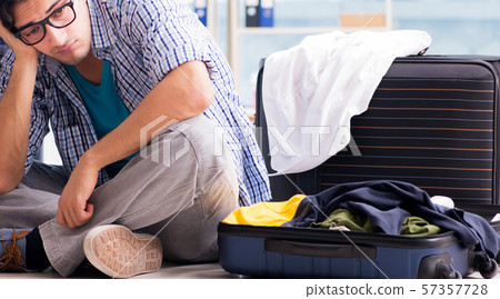Young man preparing for vacation travel Young man preparing for vacation travel 57357728