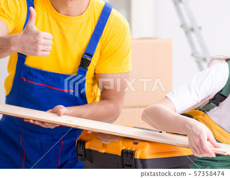 Man explaining woman woodworking tips in wood workshop Man explaining woman woodworking tips in wood workshop 57358474