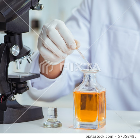 Chemist mixing perfumes in the lab Chemist mixing perfumes in the lab 57358483