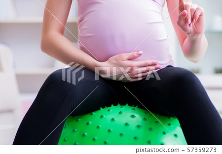 Pregnant woman exercising in anticipation of child birth 57359273