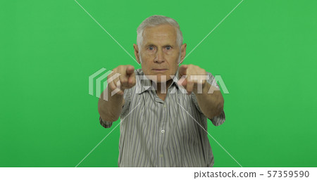 Senior man points at the camera. Handsome old man on chroma key background Senior man points at the camera. Handsome old man on chroma key background 57359590