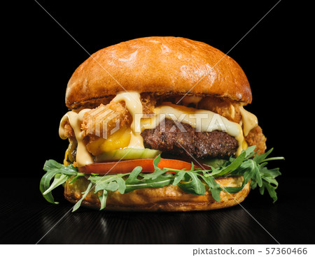 Craft burger is cooking on black background. Consist: sauce, arugula, tomato, red onion rings fries 57360466