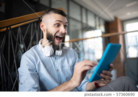 Man feeling emotional after reading message from old friend 57360690