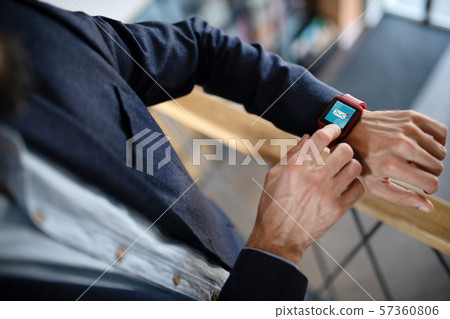 Businessman using smart watch receiving e-mail from secretary Businessman using smart watch receiving e-mail from secretary 57360806