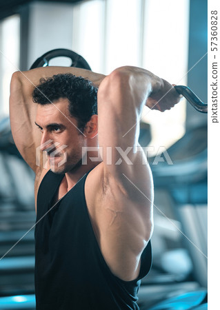 bodybuilder guy doing exercises with barbell bodybuilder guy doing exercises with barbell 57360828