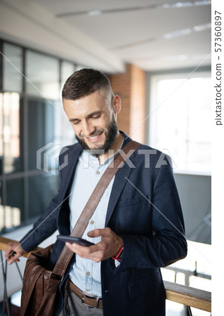 Man reading message on phone while having little break Man reading message on phone while having little break 57360897