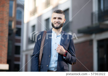 Young man wearing smart watch walking to the office Young man wearing smart watch walking to the office 57361022