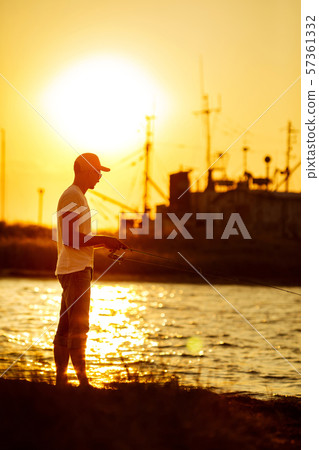 Young man fishing at sea Young man fishing at sea 57361332
