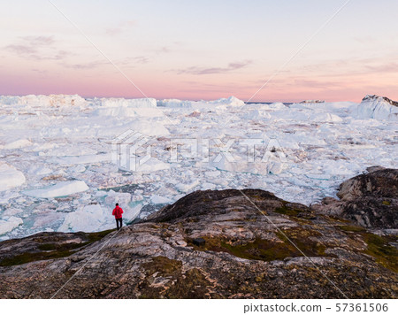 Travel in arctic landscape nature with icebergs - Greenland tourist man explorer Travel in arctic landscape nature with icebergs - Greenland tourist man explorer 57361506