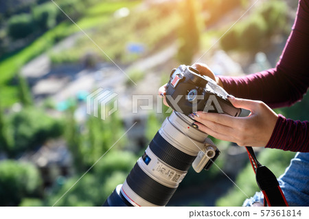photographer holding camera  57361814