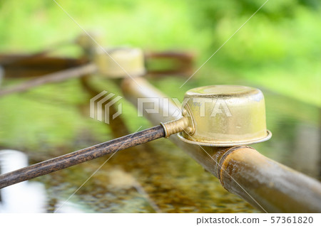 Cropped Ladle over Bamboo and water for ritual in Japan temple Cropped Ladle over Bamboo and water for ritual in Japan temple 57361820