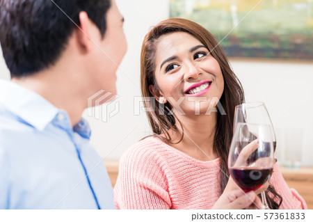 Happy couple toasting red wine glasses 57361833