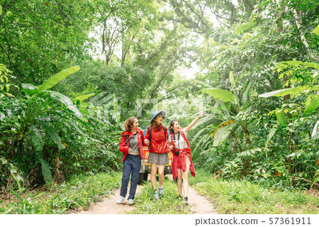 Three asian woman hiking in forest on vacation Three asian woman hiking in forest on vacation 57361911