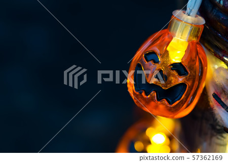 Halloween pumpkin orange Jack O'Lantern smiling face with as candle light lit on grunge background Halloween pumpkin orange Jack O'Lantern smiling face with as candle light lit on grunge background 57362169