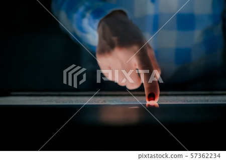 Woman using interactive touchscreen display at modern history museum Woman using interactive touchscreen display at modern history museum 57362234