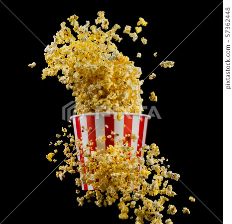 Flying popcorn from striped bucket isolated on black background Flying popcorn from striped bucket isolated on black background 57362448