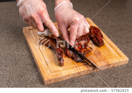 food, delicious and craft concept - Man cutting horse steak 57362815