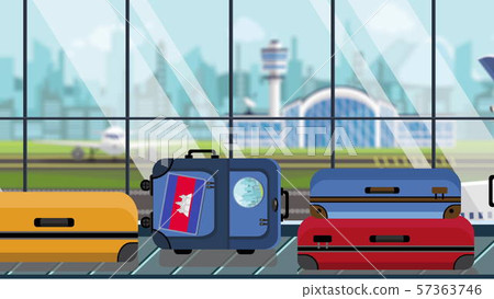 Suitcases with Cambodian flag stickers on baggage carousel in airport, close-up. Tourism in Cambodia 57363746