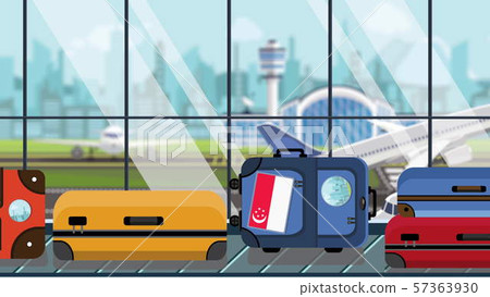 Suitcases with Singaporean flag stickers on baggage carousel in airport, close-up. Tourism in 57363930