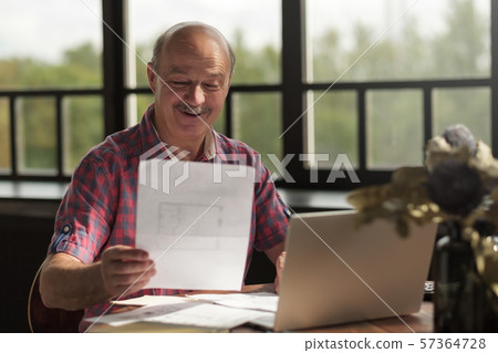 man holding plan of new flat deciding to make an investment 57364728