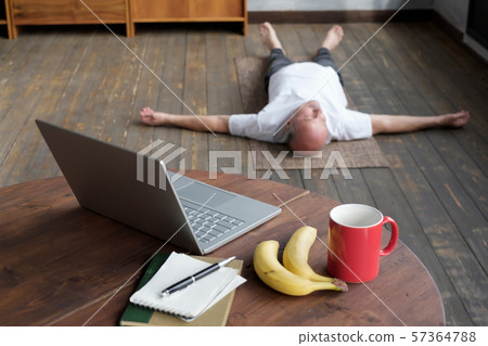 Blurred phot of senior caucasian man lying in Shavasana pose Blurred phot of senior caucasian man lying in Shavasana pose 57364788