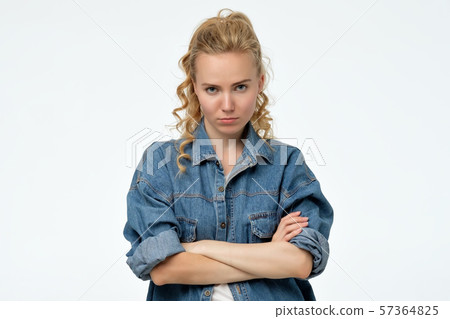 Young offended angry woman folded her arms, being angry on her boyfriend. Young offended angry woman folded her arms, being angry on her boyfriend. 57364825