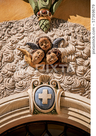 Sculpture of angels faces on church facade Sculpture of angels faces on church facade 57369679