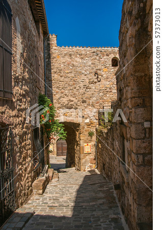 Stone houses in an alley at the hamlet of Les Arcs-sur-Argens 57373013