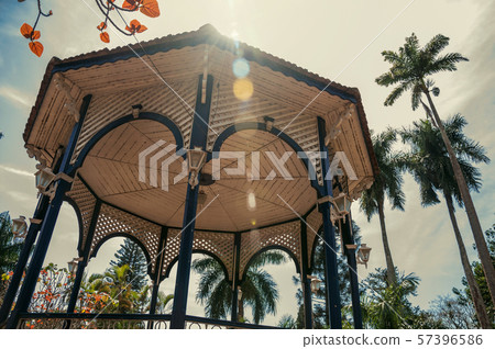 Colorful gazebo ceiling in a garden full of trees Colorful gazebo ceiling in a garden full of trees 57396586