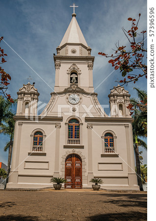 Church facade and belfry in front of a small garden at Sao Manuel Church facade and belfry in front of a small garden at Sao Manuel 57396596