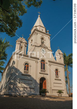 Church facade and belfry in front of a small garden at Sao Manuel Church facade and belfry in front of a small garden at Sao Manuel 57396599