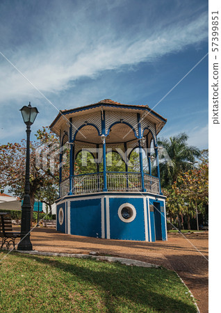 Old colorful gazebo and lighting pole in a green garden 57399851