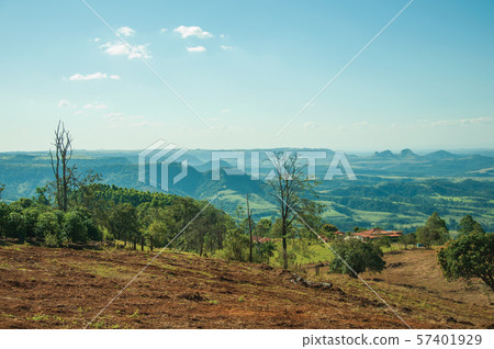 Meadows and trees in a green valley with hilly landscape Meadows and trees in a green valley with hilly landscape 57401929