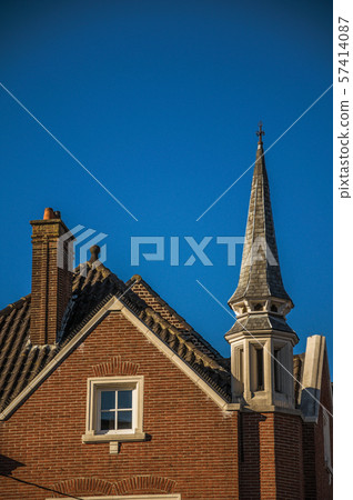 Detail of brick building facade and roofs at sunset in Tielt 57414087