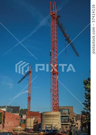 Construction area with cranes at sunset in Tielt Construction area with cranes at sunset in Tielt 57414116