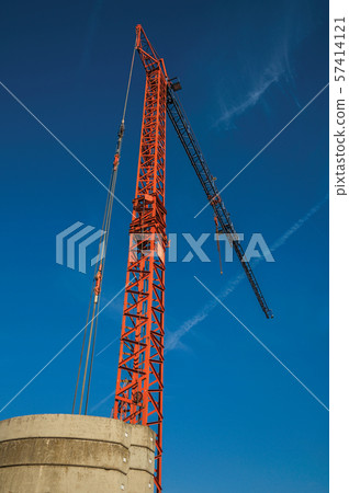 Close-up of crane in a construction area at sunset in Tielt Close-up of crane in a construction area at sunset in Tielt 57414121