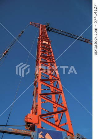 Close-up of crane in a construction area at sunset in Tielt 57414127