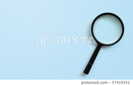 Magnifying glass on blue colour background 57419552