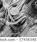 Bollard with a rope on the wooden deck of a 57436348