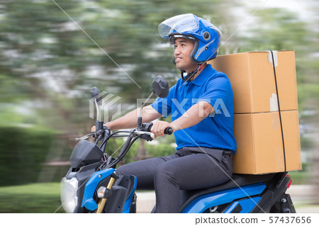 Courier delivering parcel box by motorcycle or Courier delivering parcel box by motorcycle or 57437656